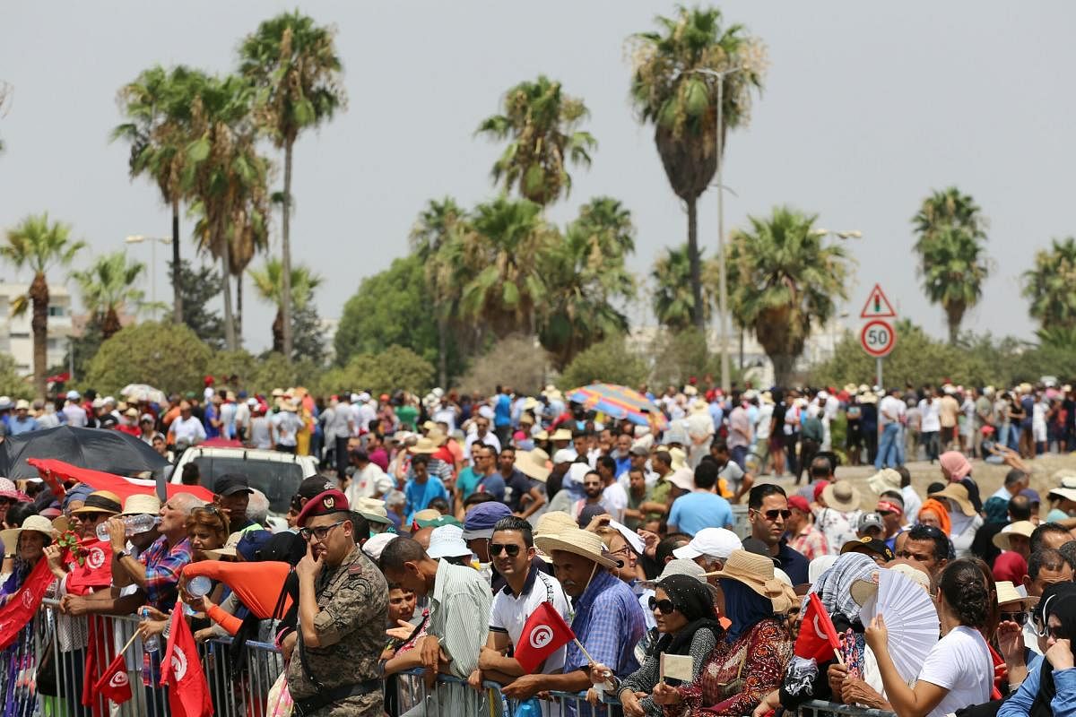 Tunisian gather for the state funeral of late president Essebsi at the El-Jellaz cemetery in Tunis on July 27, 2019. Photo AFP