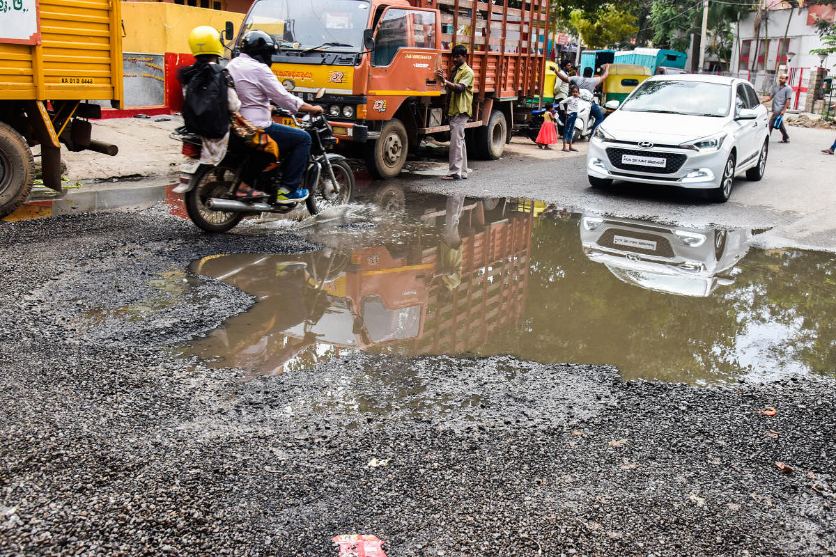 Sewage water stagnanted on the newly asphalted road, and road is fully damaged at BTS (BMTC) Road, near MICO back gate, Wilson garden, in Bengaluru on Sunday. Photo by S K Dinesh