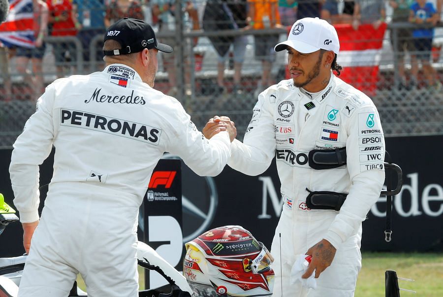 Lewis Hamilton (right) is congratulated by his Mercedes team-mate Valtteri Bottas after the former bagged pole position for the German Grand Prix. Picture credit: Reuters