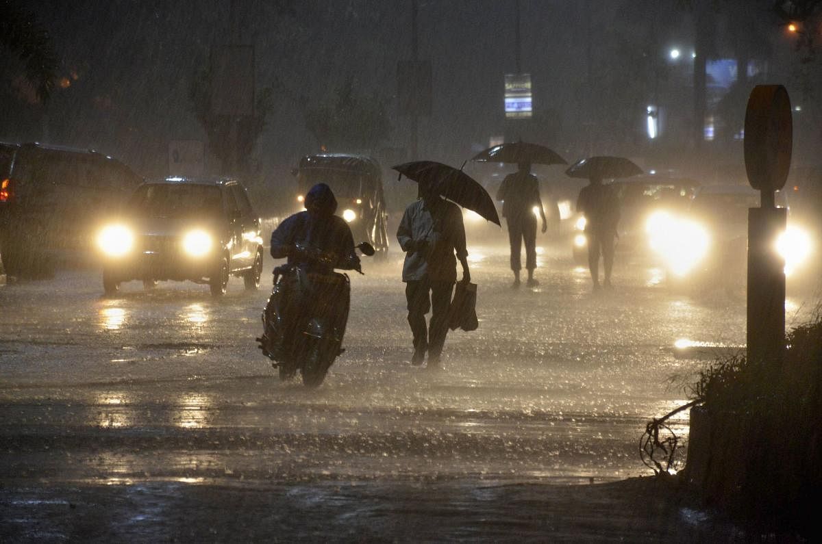 Vehicles ply near Vashi railway station during heavy monsoon rain, in Navi Mumbai (PTI Photo)