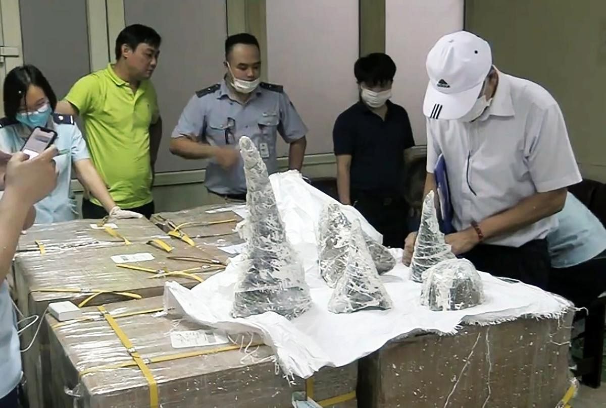 Images of the bust show large rhino horns and smaller pieces sitting on a table and police using rods to break the casts apart. (AFP Photo)