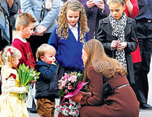 Kate receives flowers from children during her visit to Humberside Fire and Rescue Service, in Grimsby, on Tuesday. AP