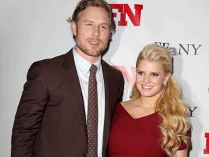 FILE - In this Nov. 29, 2011 file photo, singer Jessica Simpson, right, poses with Eric Johnson at the 25th Annual Footwear News Achievement Awards at The Museum of Modern Art in New York. Simpson's rep confirmed that the entertainer gave birth to Ace Knute in Los Angeles on Sunday, June 30, 2013, via planned C-section. This is the second child for Simpson and her fiance, Eric Johnson. Simpson gave birth to daughter Maxwell last year. AP photo