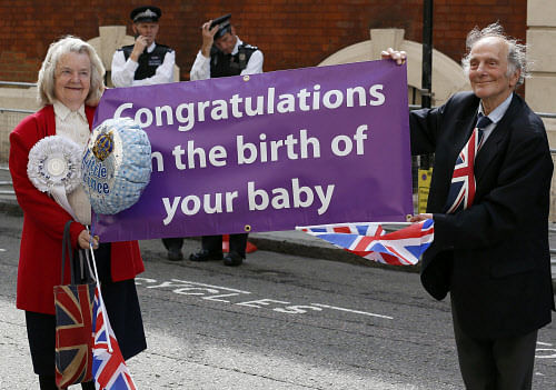 Well-wishers hold a sign in front of the Lindo Wing of St Mary's Hospital, the morning after Britain's Catherine, Duchess of Cambridge gave birth to a baby boy in London July 23, 2013. Prince William's wife Kate gave birth on Monday to a boy, who becomes third in line to the British throne, ending weeks of feverish speculation about the royal baby. The couple's first child was born at 4:24 p.m. (1524 GMT), weighing 8 lbs and 6 oz. His name will be announced at a later date but bookmakers favour George and James. REUTERS