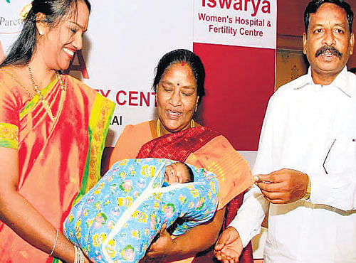 Forty-two-year-old Latha, a cancer survivor, with her newborn baby in Chennai.