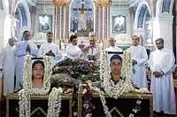 Final Journey: Mangalore Diocesan Bishop Dr Aloysius Paul DSouza blesses the mortal remains of Saritha DSouza and Naveen Fernandes who died in the Mangalore aircraft crash, at Holy Cross Church at Kulshekar in Mangalore on Monday.