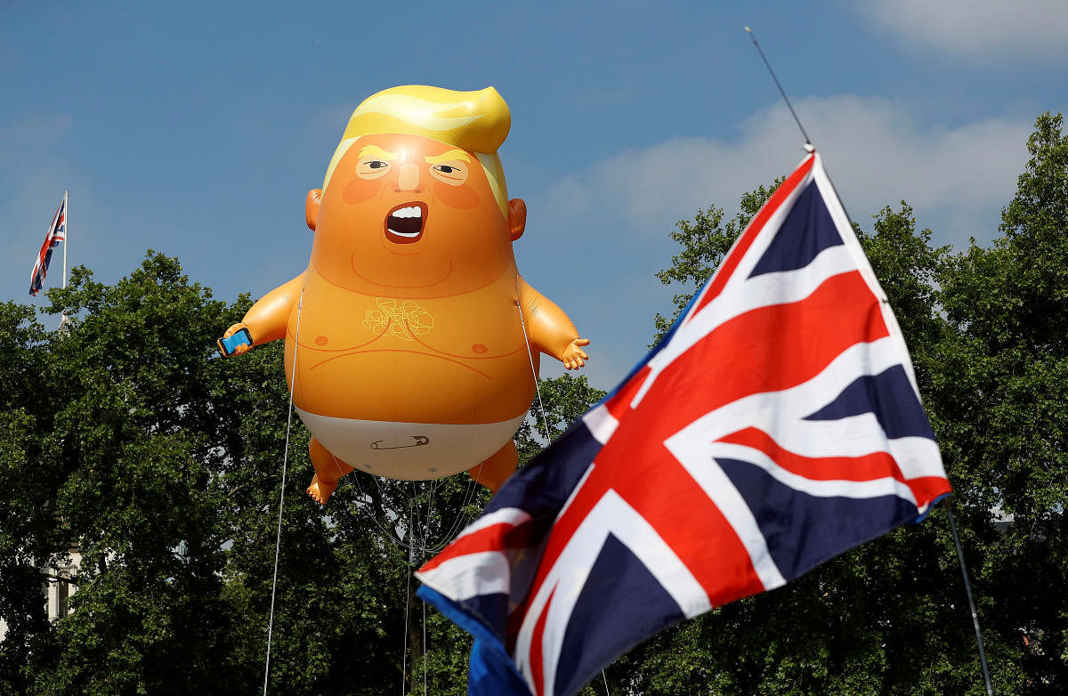 A few hundred people gathered to watch the blimp launch in Parliament Square, with organisers of the stunt wearing red boiler suits and red baseball caps emblazoned with "TRUMP BABYSITTER". (Reuters Photo)