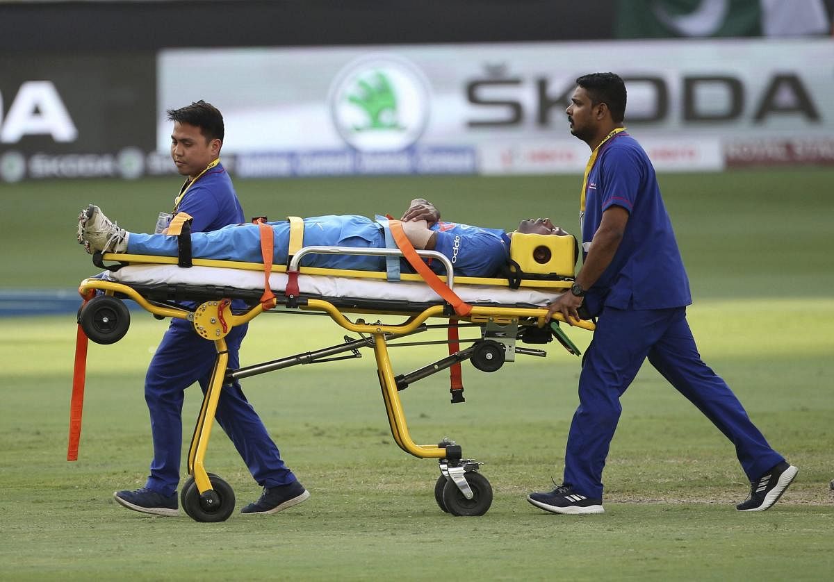Hardik Pandya is taken out of the field on a stretcher after he fell after bowling a delivery during the one day international cricket match of Asia Cup between India and Pakistan in Dubai. AP/PTI Photo