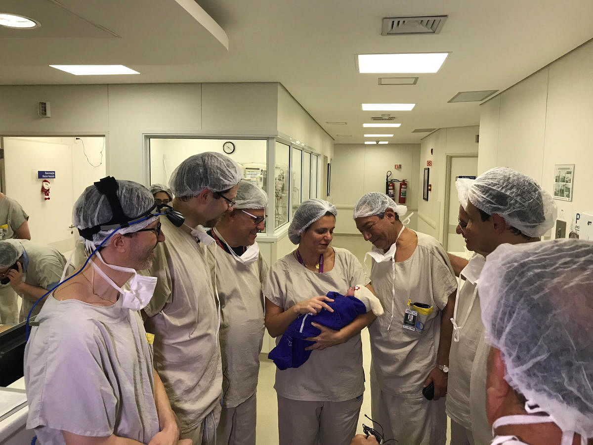 Medical team hold the first baby born via uterus transplant from a deceased donor at the hospital in Sao Paulo, Brazil December 15, 2017 in this picture handout obtained on December 4, 2018. (Hospital das Clinicas da FMUSP/via REUTERS)