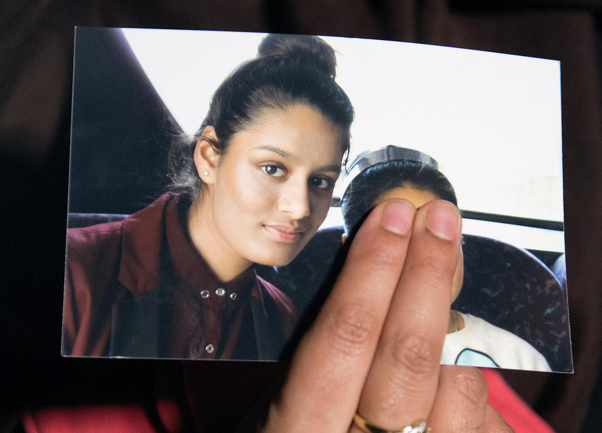 Renu Begum, sister of teenage British girl Shamima Begum, holds a photo of her sister as she makes an appeal for her to return home at Scotland Yard, in London, Britain. (Reuters File Photo)