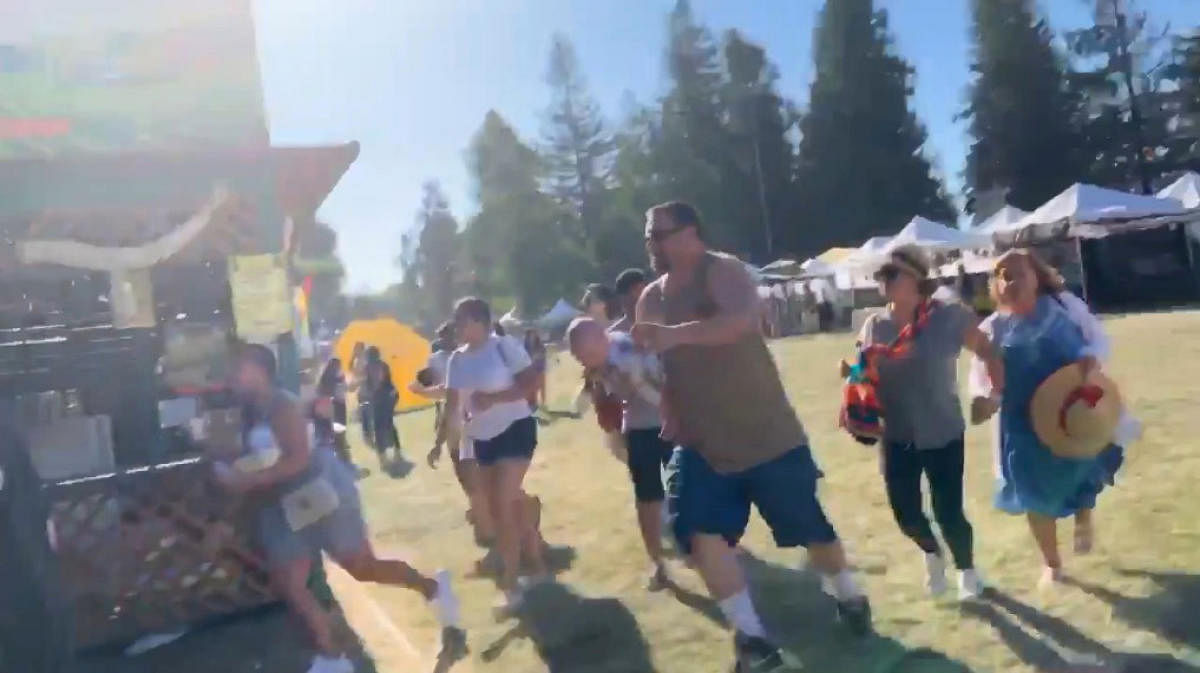 People run as an active shooter was reported at the Gilroy Garlic Festival, south of San Jose, California, U.S., July 28, 2019 in this still image taken from a social media video. (Courtesy of Twitter @wavyia/Social Media via REUTERS)