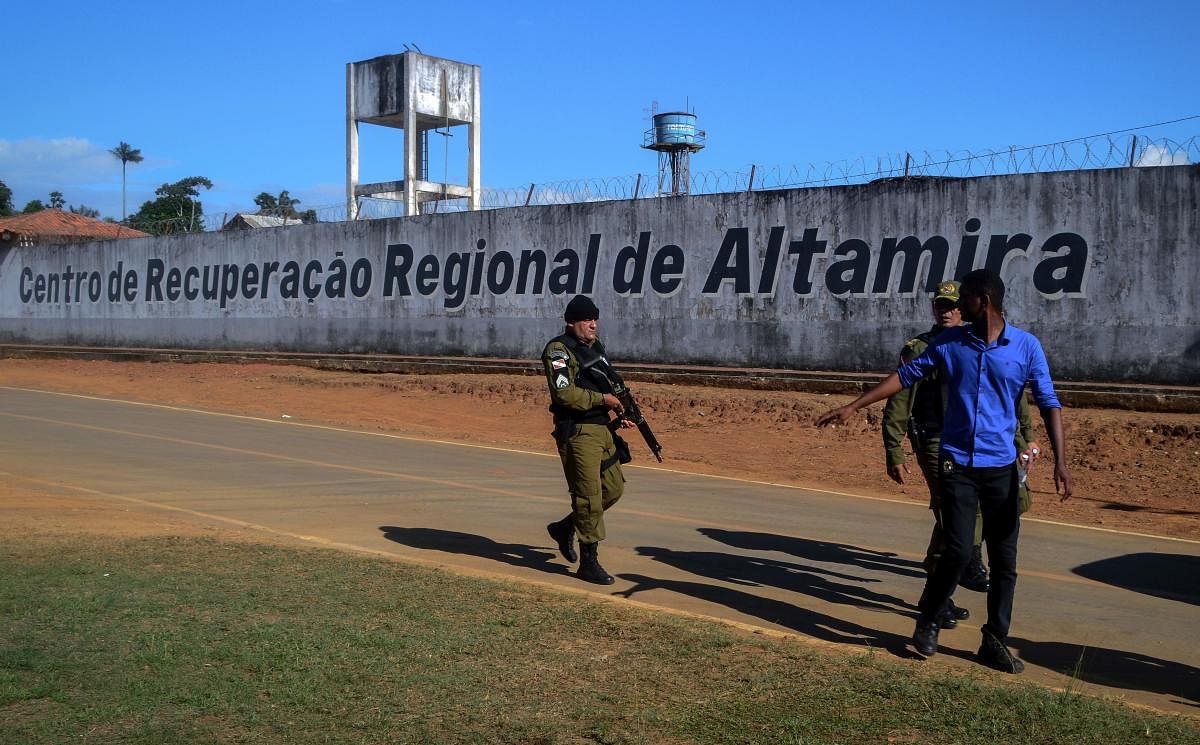A police officer patrols the surroundings of the Altamira Regional Recovery Centre after at least 57 inmates were killed in a prison riot, in the Brazilian northern city of Altamira, Para State (AFP Photo)
