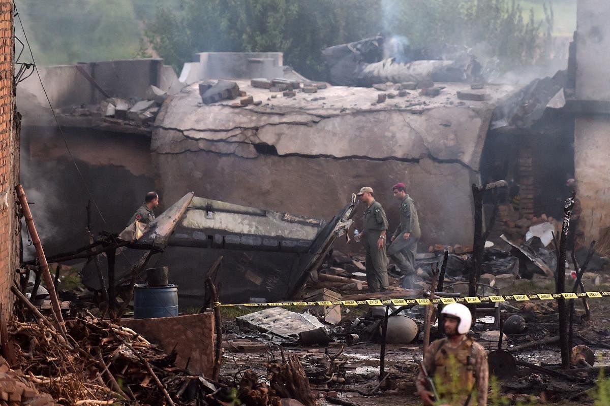 Pakistani soldiers cordon off the site where a Pakistani Army Aviation Corps aircraft crashed in Rawalpindi on July 30, 2019. (AFP Photo)