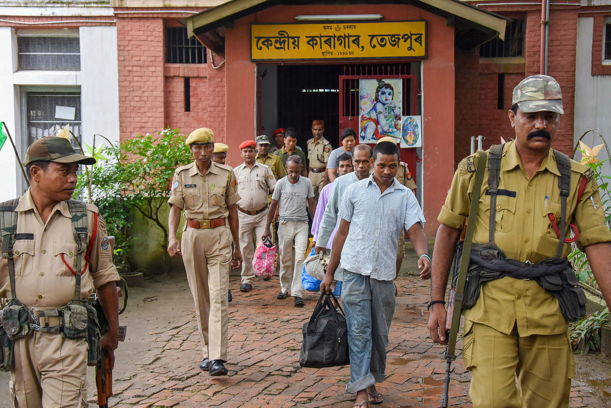  Four Bangladeshi nationals being escorted from the detention centre, at least 25 persons have died (PTI Photo)