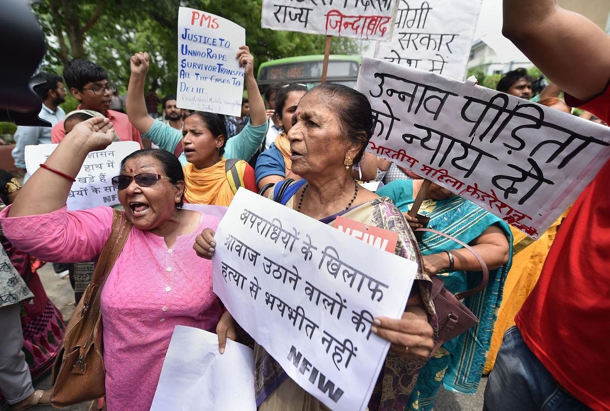 Women activists raise slogans as they stage a protest demonstration over the Unnao case, outside the UP Bhawan. Photo credit: PTI