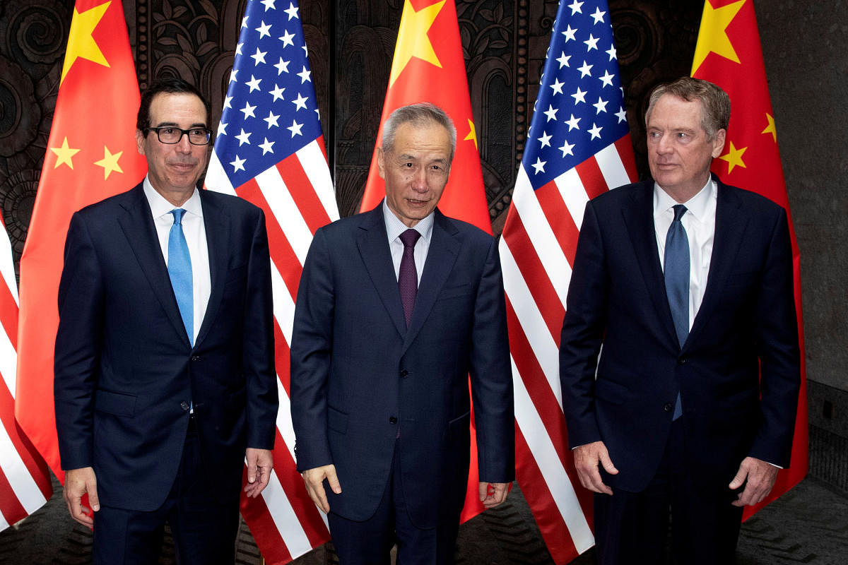 Chinese Vice Premier Liu He with United States Trade Representative Robert Lighthizer and Treasury Secretary Steven Mnuchin pose for photos before holding talks at the Xijiao Conference Center in Shanghai. Photo credit: Reuters