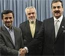 Iranian President Mahmoud Ahmadinejad, left, shakes hands with Pakistani Prime Minister Yousuf Raza Gilani, as Iranian Vice-President Mohammad Reza Rahimi, looks on September 12, 2011 in Tehran. AP File Photo