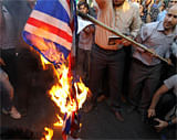 Iranians burn the US, British and French flags during a protest. AFP Photo
