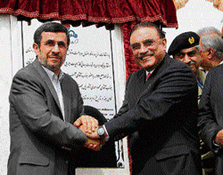 Common interest: Iran's President Mahmoud Ahmadinejad (L) and Pakistan's President Asif Ali Zardari shake hands after unveiling a plaque during a ceremony marking the start of pipeline from Iran to Pakistan on Monday in the border city of Chah Bahar.  afp