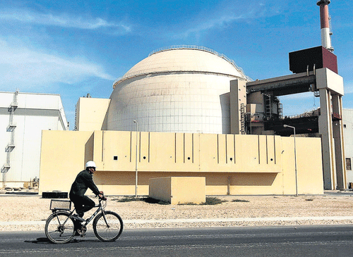 BETTER CHANCES: A worker rides a bicycle in front of the reactor building of the Bushehr nuclear power plant, just outside the southern city of Bushehr, Iran. AP