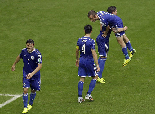 Bosnia defender Avdija Vrsajevic, right, celebrates his goal with his teammates during the second half of a group F World Cup soccer match Iran at the Arena Fonte Nova in Salvador, Brazil, Wednesday, June 25, 2014.  AP photo