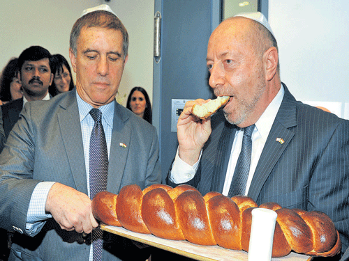 Israel's Ambassador to India Daniel Carmon (left) along with Acting Consul General for Israel, Ambassador DovSegev Steinberg, breaks bread as part of a ritual during the opening of the Consulate General of Israel in Bengaluru on Thursday. DH photo