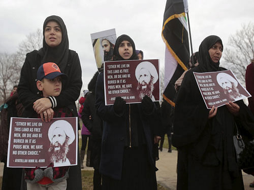 Muslim American women hold signs as they protest against the execution of Shi'ite Muslim cleric Nimr al-Nimr in Saudi Arabia, during a rally in Dearborn, Michigan January 3, 2016. REUTERS Photo