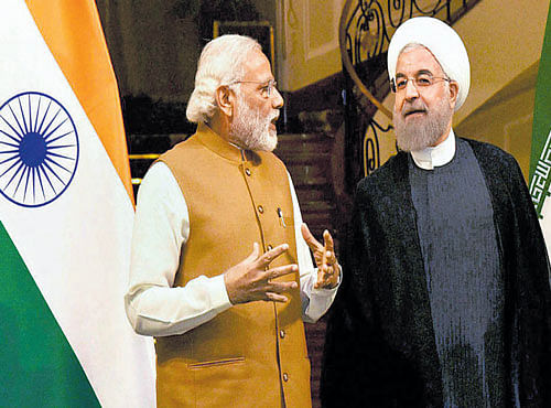Prime Minister Narendra Modi with Iranian President Hassan Rouhani in Tehran on Monday. PTI