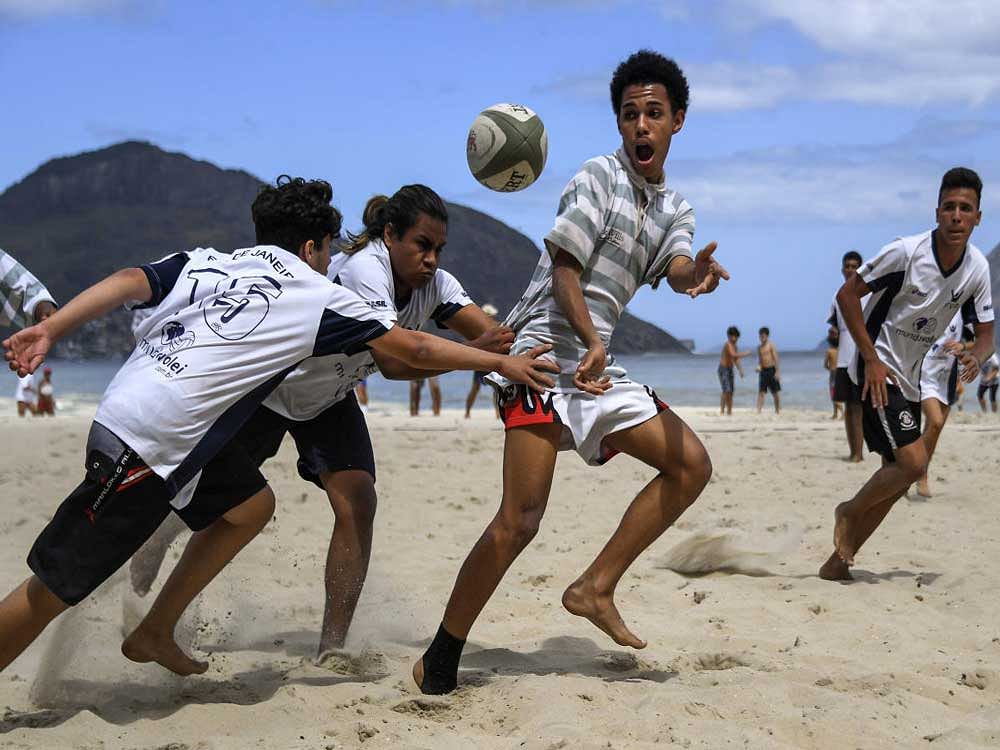 new rhythm Youngsters play rugby during a school tournament at a beach in Rio de Janeiro.Th e sport is slowly gaining ground in the South American country. AFP