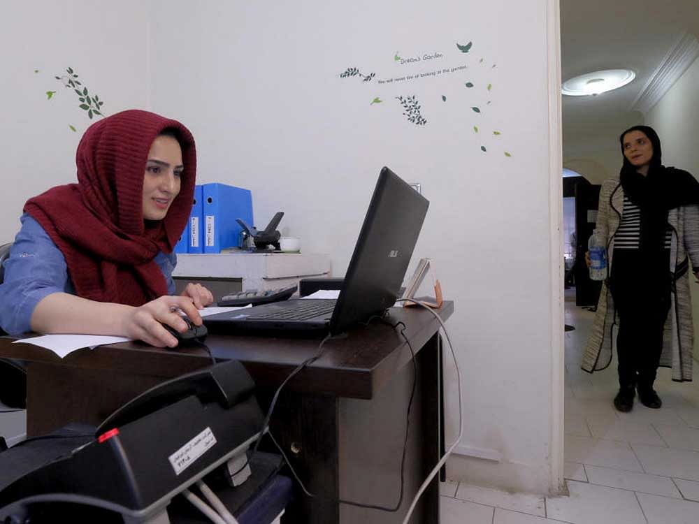 An employee works with her laptop at Takhfifan company in Tehran, Iran January 19, 2016. REUTERS