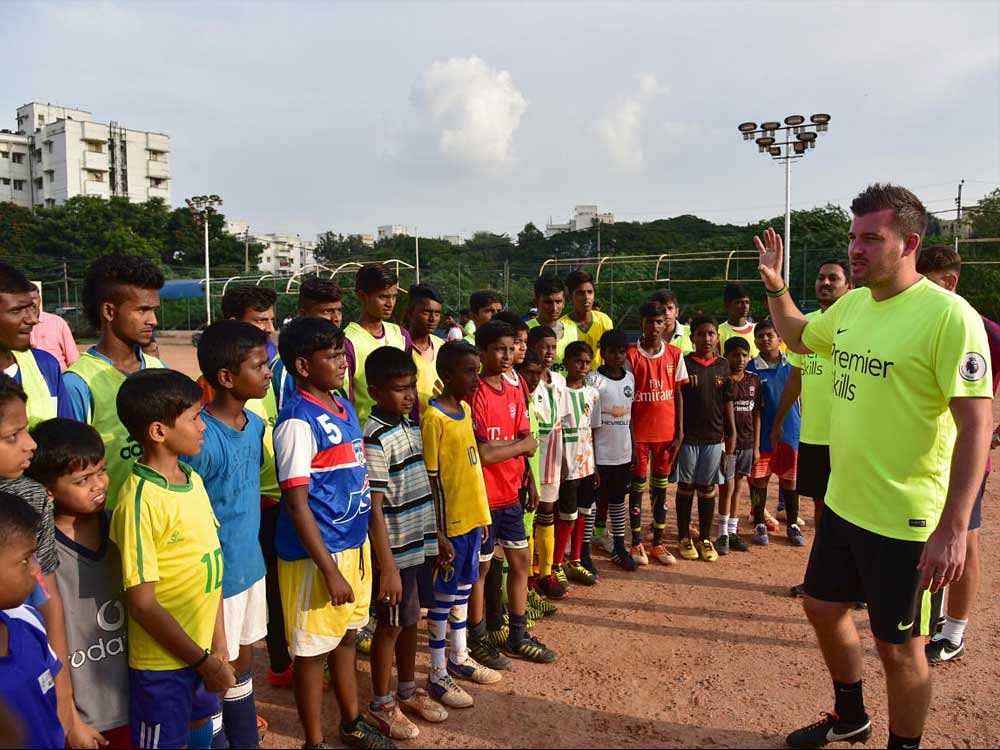 Paul Hughes, Premier Skills head coach,  interacts with young players in Bengaluru on Sunday. DH photo