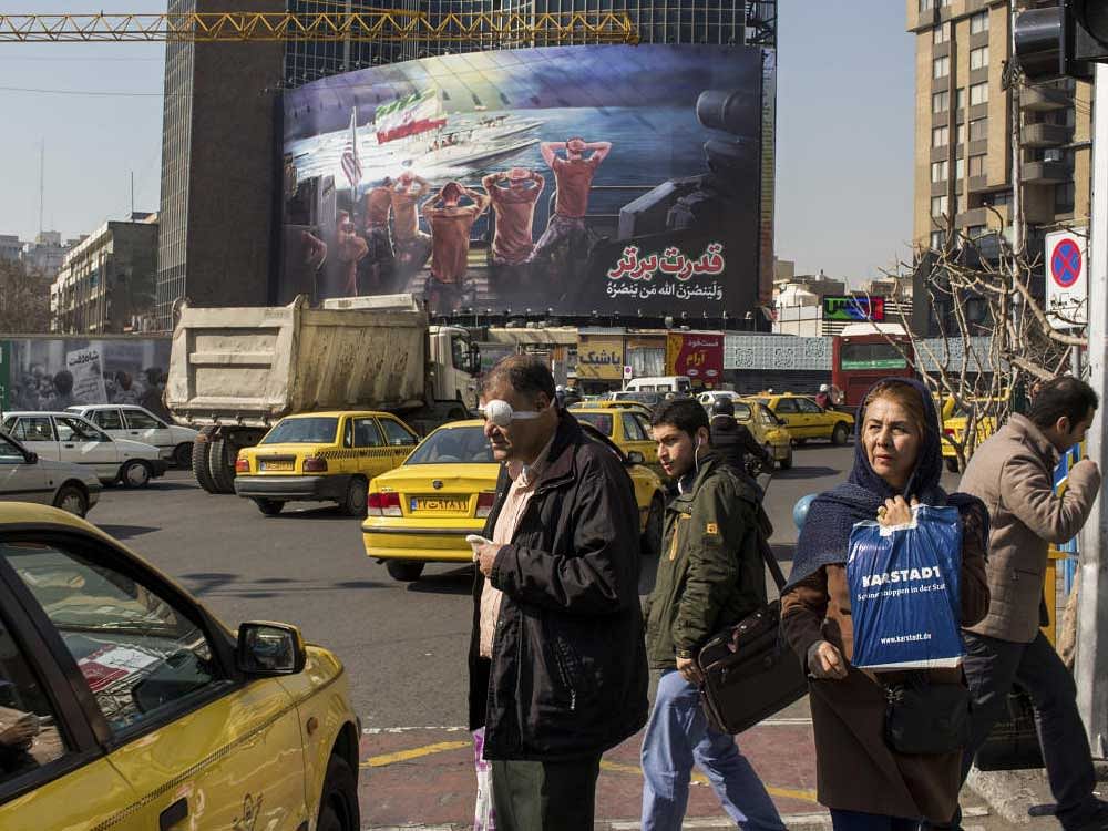 A billboard in Tehran shows Revolutionary Guards in speedboats in the Persian Gulf. With many sanctions lifted after the nuclear deal, as the government tries to open the country to foreign investment, the group's economic dominance is seen as a liability. NYT