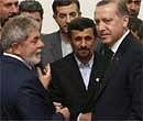 Iranian President Mahmoud Ahmadinejad, center, his Brazilian counterpart Luis Inacio Lula da Silva, left, and Turkish Prime Minister Recep Tayyip Erdogan, right, talk before signing an agreement to ship most of Iran's enriched uranium to Turkey in a nuclear fuel swap deal, in Tehran on Monday. AP