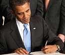 US President Barack Obama signs the Iran Sanctions Bill at the East Room of the White House in Washington on Thursday. AFP