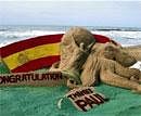 Sand artist Sudarsan Pattnaik's sand sculpture of Paul, the 'psychic' octopus and the national flag of Spain in Puri on Monday . PTI