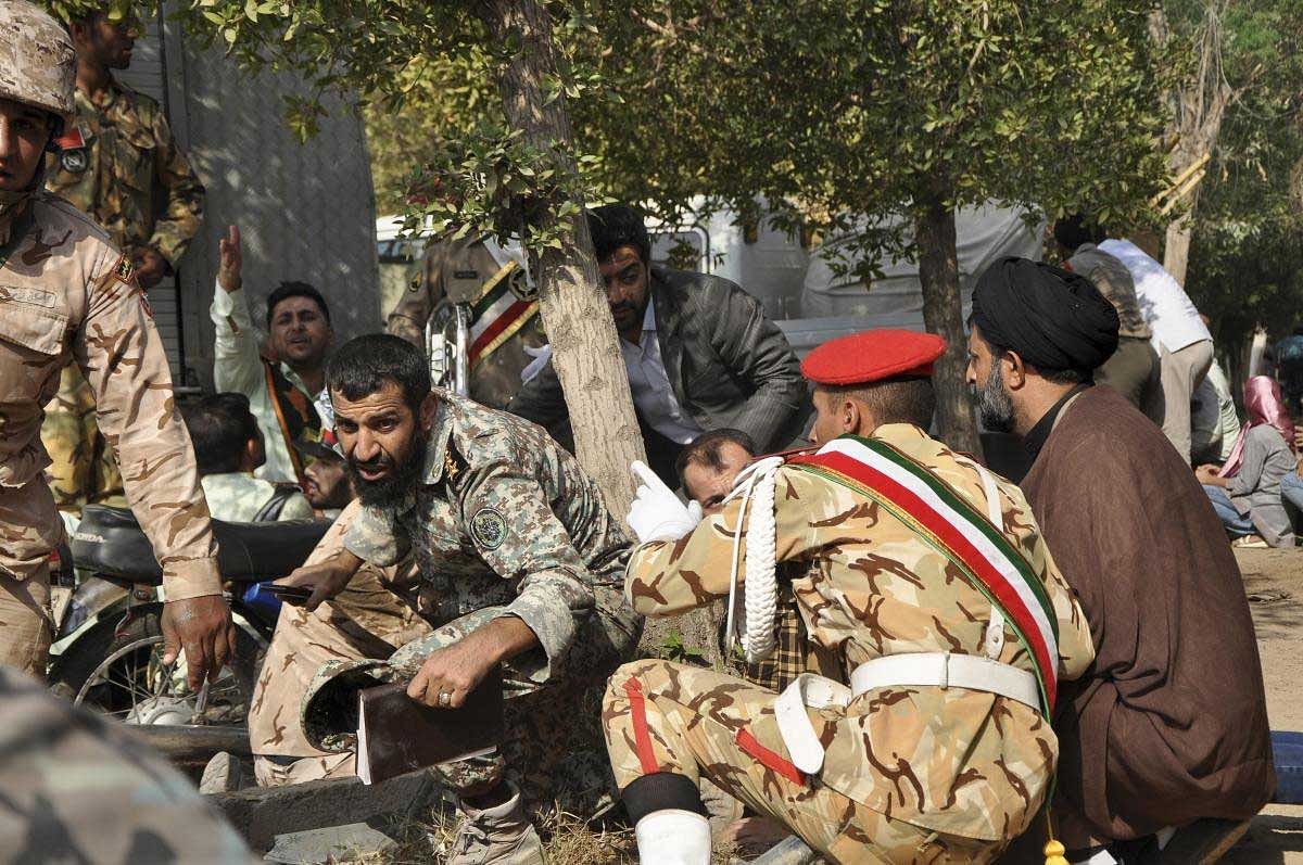 In this photo provided by the Iranian Students' News Agency, ISNA, Iranian armed forces members and civilians take shelter in a shooting during a military parade marking the 38th anniversary of Iraq's 1980 invasion of Iran, in the southwestern city of Ahvaz, Iran, Saturday, Sept. 22, 2018. Gunmen attacked the military parade, killing at least eight members of the elite Revolutionary Guard and wounding 20 others, state media said. AP/PTI