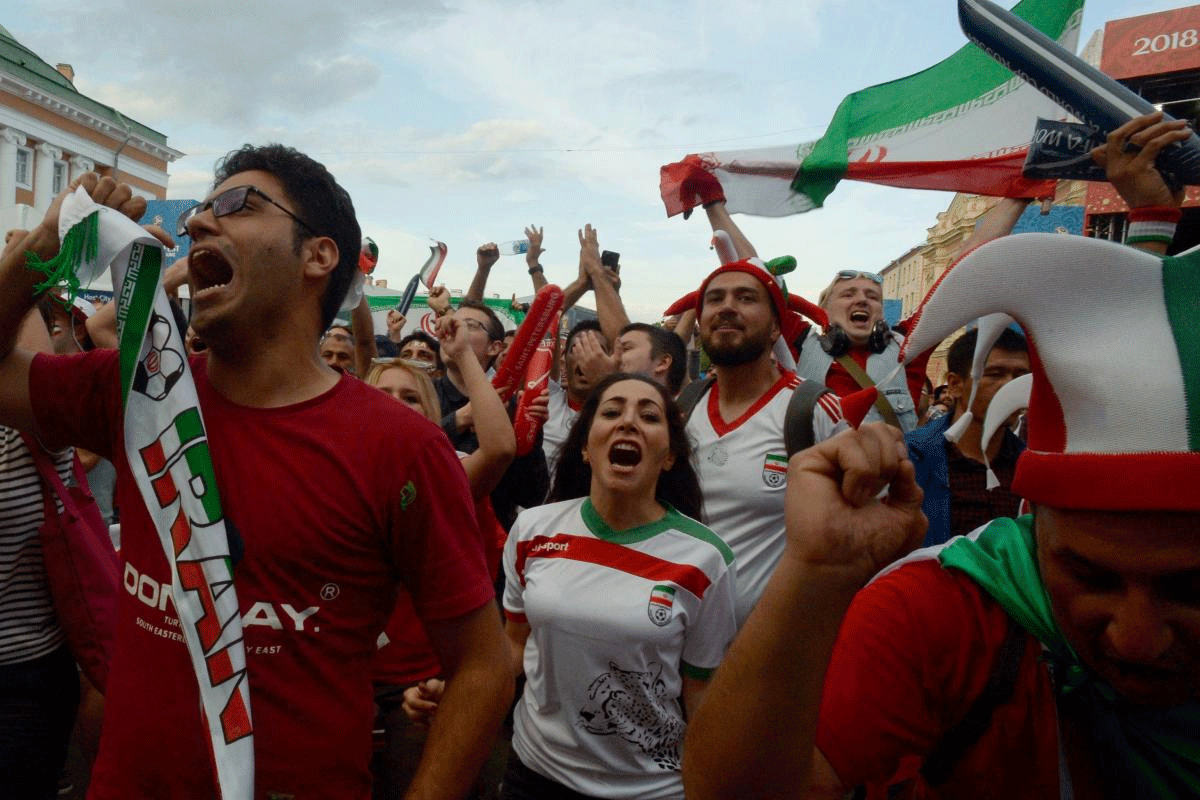 Iran's fans with Iranian national flag celebrate the victory after Russia 2018 World Cup Group B football match between Iran and Morocco at the Fifa Fans Fest in Saint Petersburg on June 15, 2018. AFP PHOTO
