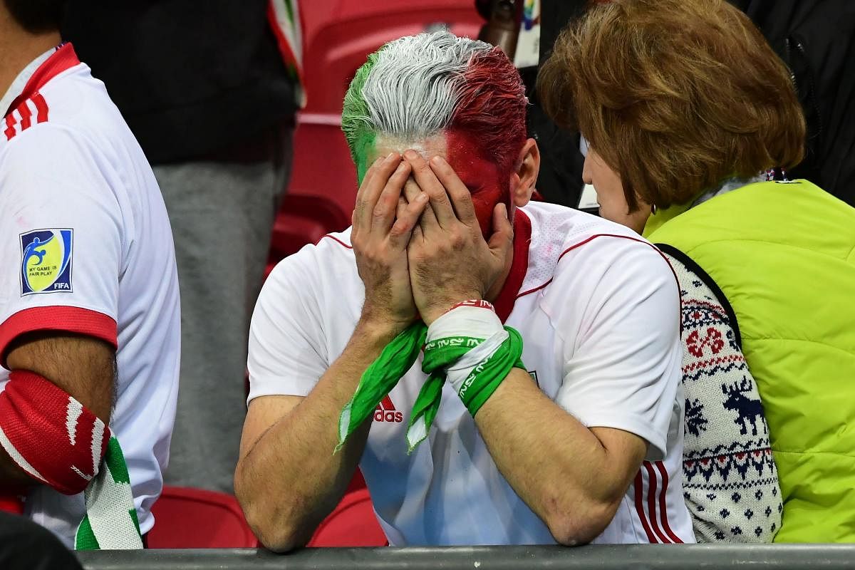 An Iranian fan reacts after the team's defeat to Spain on Wednesday. AFP