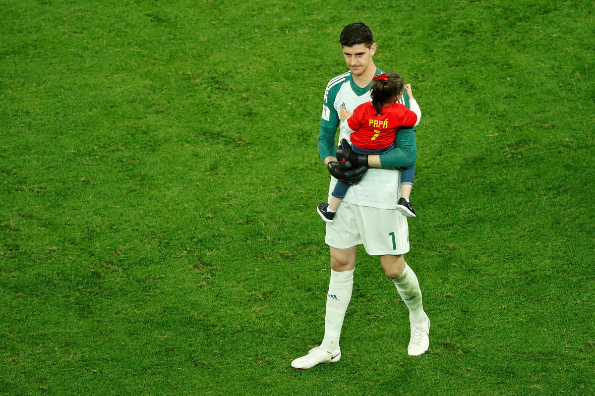 Belgium's Thibaut Courtois holds his daughter as he looks dejected after the match (REUTERS/Anton Vaganov)