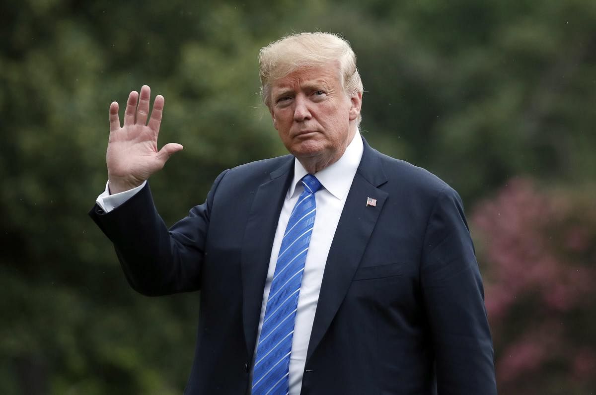 :President Donald Trump waves as he walks on the South Lawn after stepping off the Marine One helicopter at the White House, Tuesday, July 24, 2018, in Washington. Trump is returning from a trip to Kansas City, Mo. AP/PTI