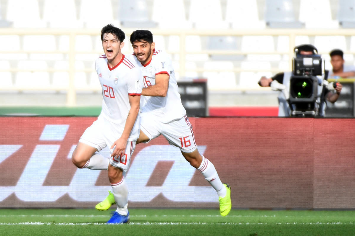 Iran’s forward Sardar Azmoun (left) celebrates after scoring against Vietnam in the Asian Cup. AFP