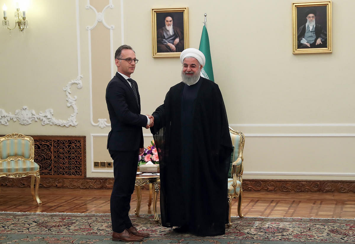 President Hassan Rouhani (R) shaking hands with German Foreign Minister Heiko Maas in the capital Tehran. (AFP Photo)