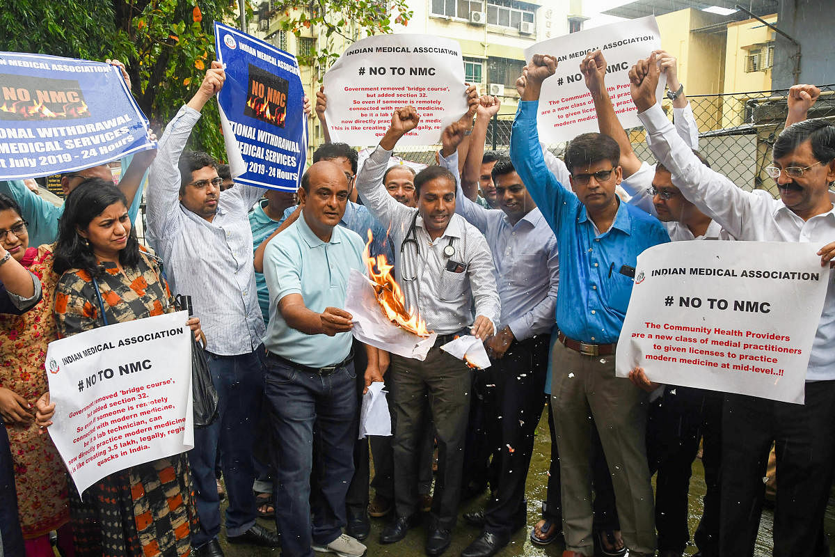 Junior doctors and medical students hold placards as they protest against the National Medical Commission (NMC) Bill-2019 in Thane district, Wednesday, July 31, 2019. (PTI Photo)