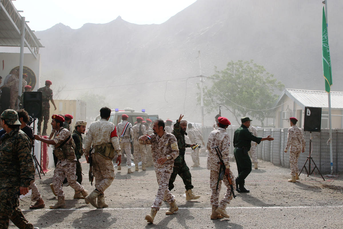Soldiers rush to help the injured following a missile attack on a military parade during a graduation ceremony for newly recruited troopers in Aden, Yemen. Reuters photo