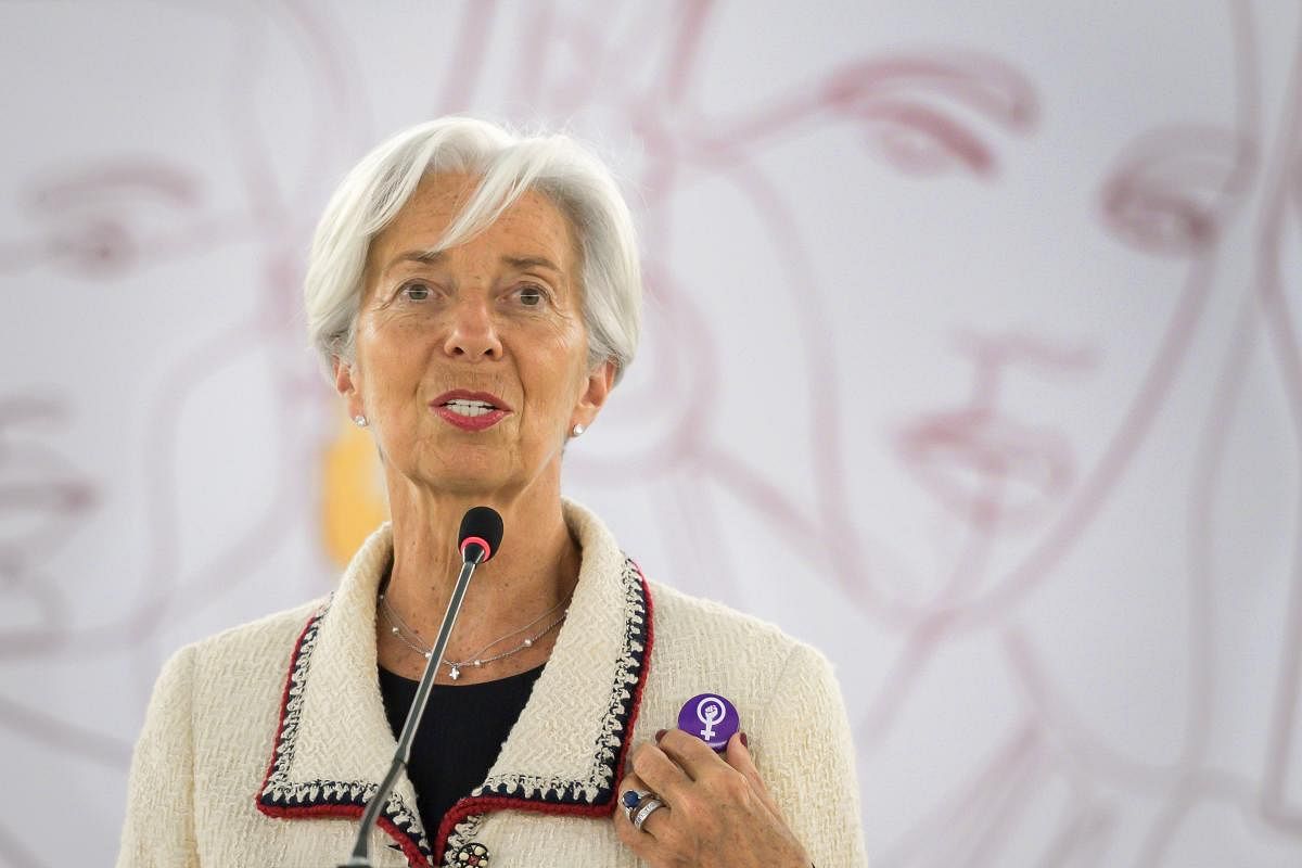 International Monetary Fund (IMF) Managing Director Christine Lagarde shows a pin's she holds in solidarity with a Swiss nation-wide women's strike for wage parity during her speech at the ILO International Labour Conference in Geneva. (Photo by AFP)