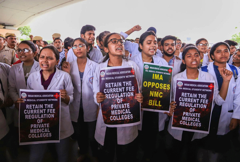 Doctors and medical students of AIIMS display placards during a strike to protest the introduction of the National Medical Commission (NMC) Bill in the Rajya Sabha, in New Delhi. (PTI Photo)