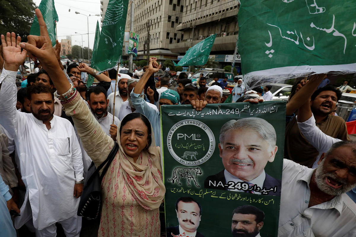 Supporters of Shehbaz Sharif, brother of ousted prime minister Nawaz Sharif and leader of Pakistan Muslim League -Nawaz (PML-N), chant slogans against what they say is alleged rigging by the Election Commission of Pakistan (ECP) during the general electio