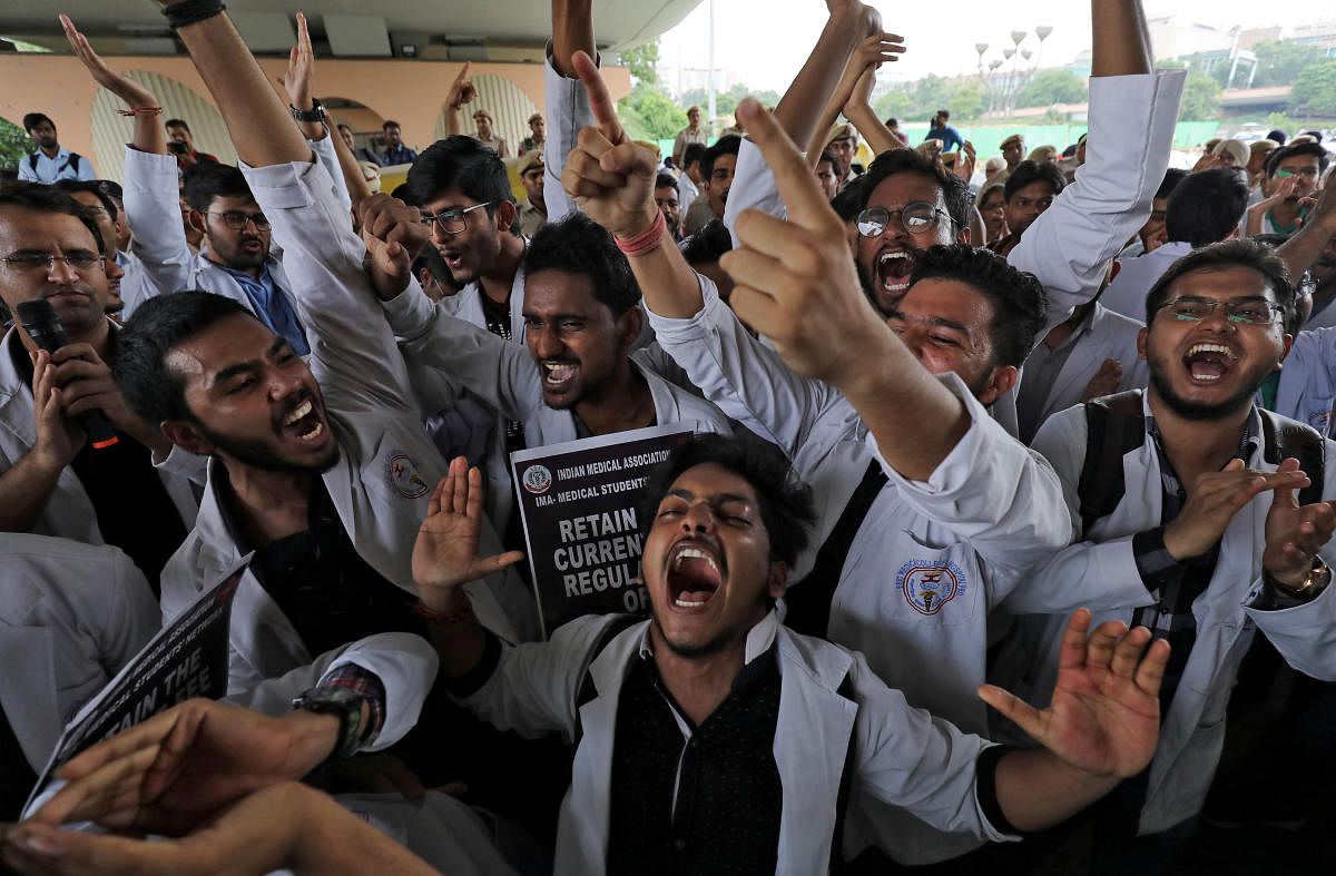 Medical students shout slogans during a protest against National Medical Commission (NMC) Bill, which they say will result in deterioration of medical studies and services, in New Delhi. (Reuters Photo)