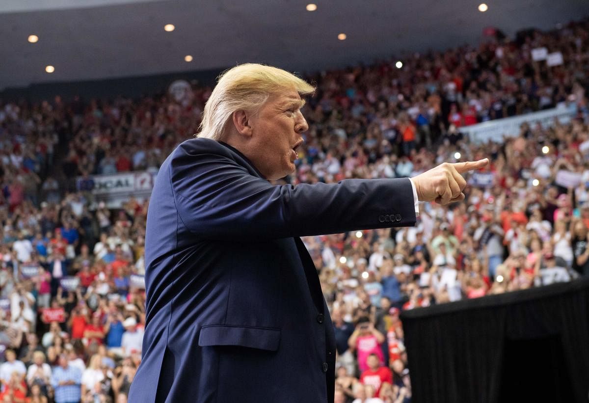US President Donald Trump gestures as he arrives to a "Make America Great Again" campaign rally in Cincinnati, Ohio, on August 1, 2019. (AFP)