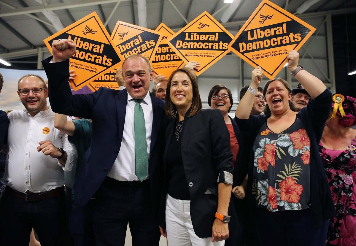 Liberal Democrat candidate Jane Dodds (C) celebrates with Liberal Democrat MP Ed Davey (L) and her team after winning the Brecon and Radnorshire by-election at the Royal Welsh Showground on August 2, 2019 in Builth Wells, Wales. (AFP)